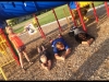 2 people acting like snakes under the playground equipment - STYLE Other kid